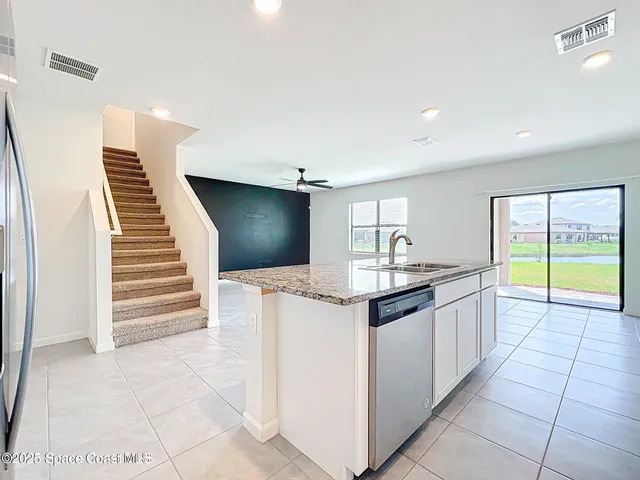 a kitchen with granite countertop a sink and a stove