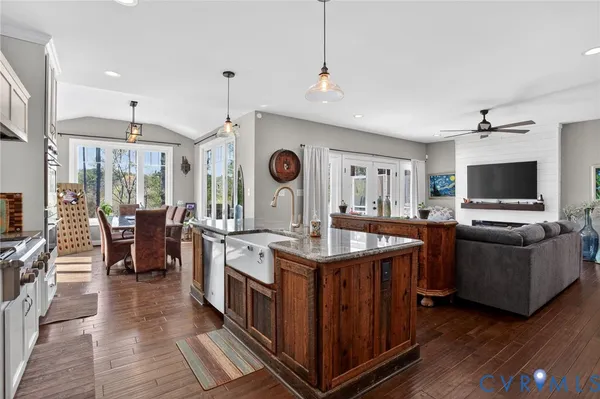 a kitchen with stainless steel appliances granite countertop a stove and a wooden floors
