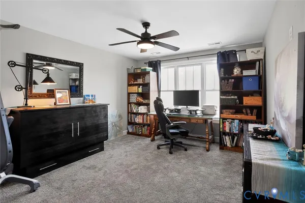 a view of a workspace with furniture and cabinet