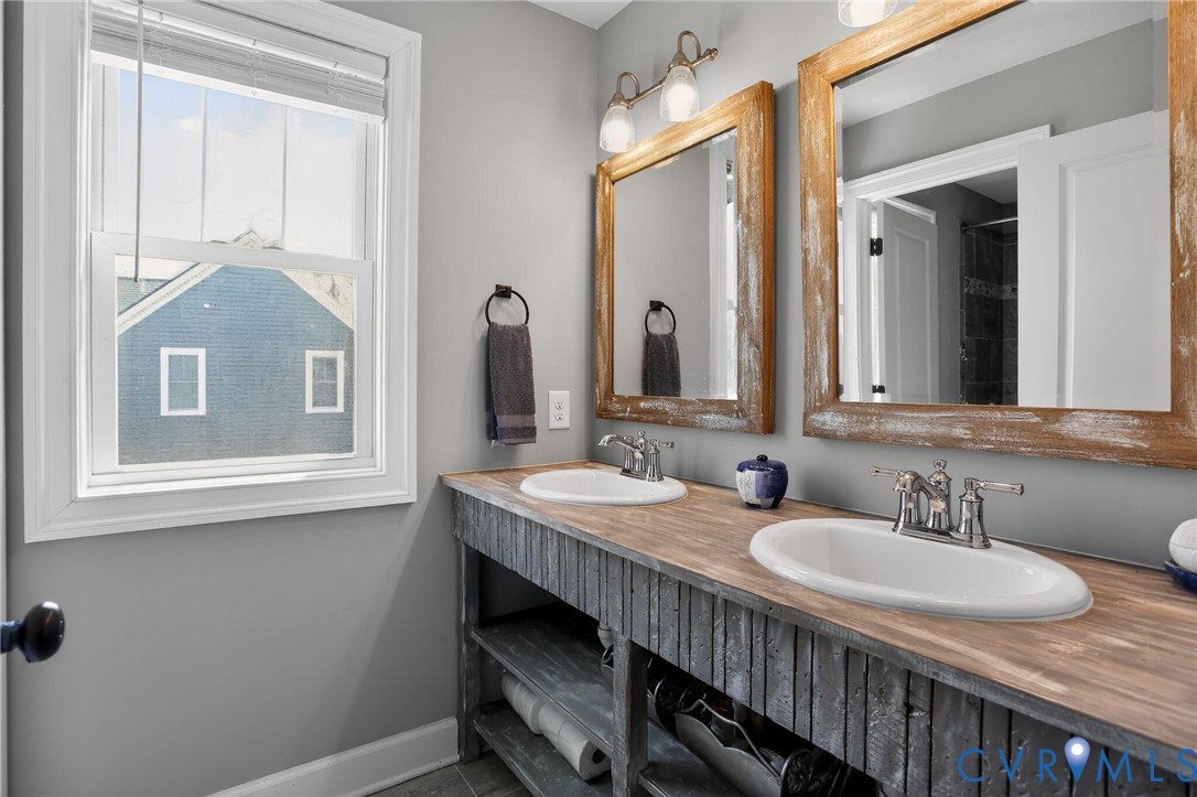 4 Walters Lane Poquoson, VA 23662 - Photo 28 of 35 a bathroom with a granite countertop sink a mirror and a vanity