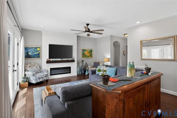 a living room with furniture a fireplace and a flat screen tv