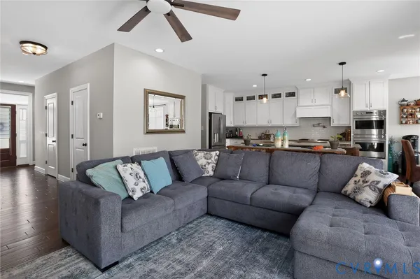 a living room with furniture and kitchen view