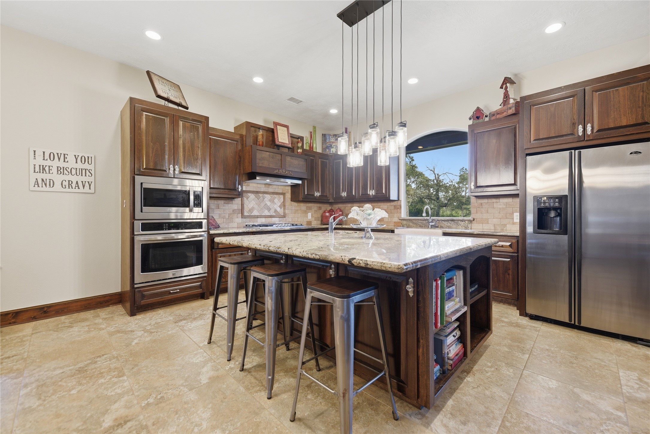 8595 Jared Road Bellville, TX 77418 - Photo 11 of 45 Island with built bookshelves, second sink and room for seating