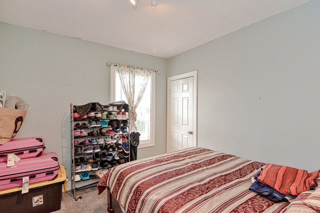 83 Ward Street Worcester, MA 01610 - Photo 12 of 28 a bedroom with a bed and a window