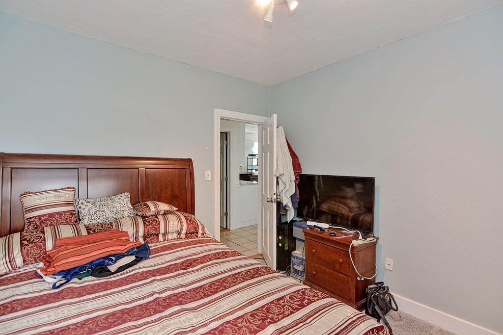 83 Ward Street Worcester, MA 01610 - Photo 13 of 28 a bedroom with furniture and a flat screen tv