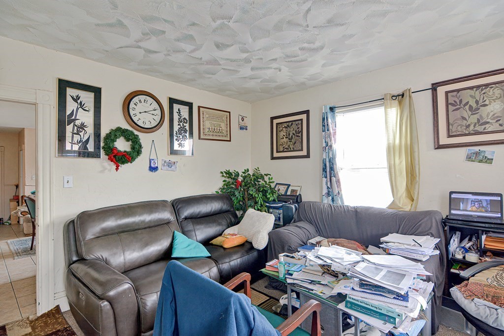83 Ward Street Worcester, MA 01610 - Photo 15 of 28 a living room with furniture and a window