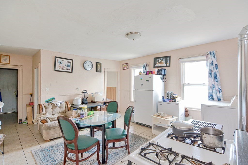 83 Ward Street Worcester, MA 01610 - Photo 16 of 28 a dining room with furniture a rug and a window