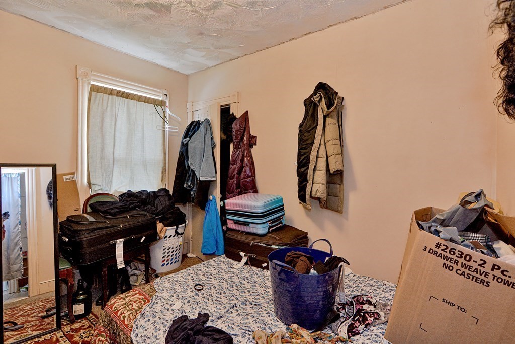 83 Ward Street Worcester, MA 01610 - Photo 19 of 28 a bedroom with a bed and a closet