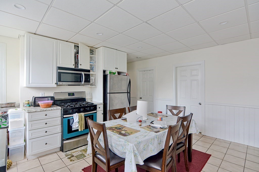 83 Ward Street Worcester, MA 01610 - Photo 7 of 28 a kitchen that has a table and chairs in it