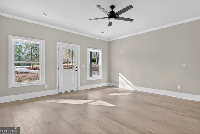 a view of a livingroom with a ceiling fan and window