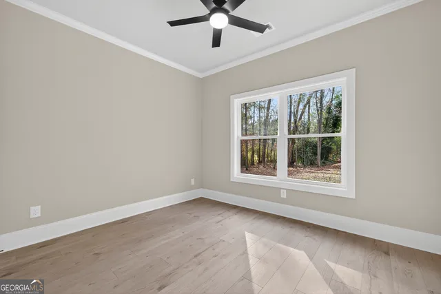 wooden floor in an empty room with a window