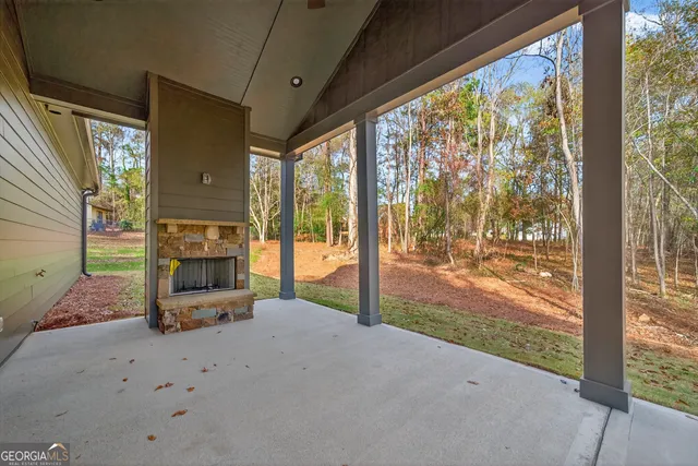 a living room with fireplace furniture and a floor to ceiling window