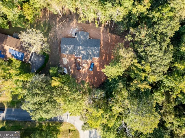 a view of a house with a tree in the background