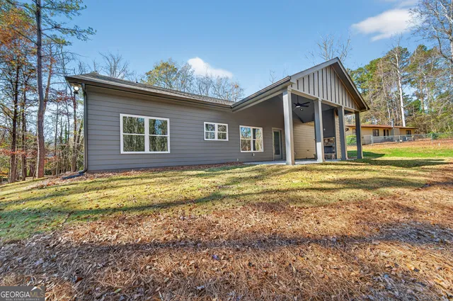 a view of a house with a yard and sitting area