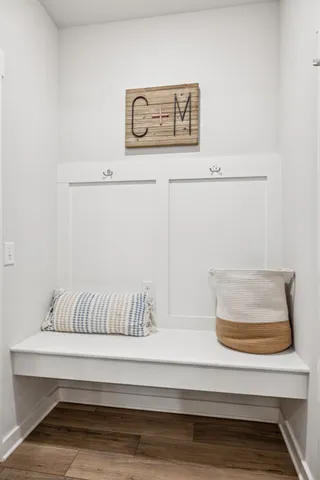 a kitchen with a table chairs microwave and cabinets