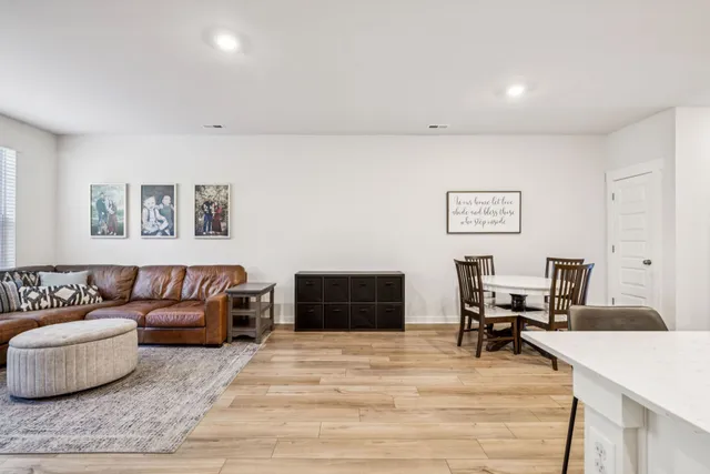 a kitchen with stainless steel appliances kitchen island granite countertop a dining table chairs and granite counter tops