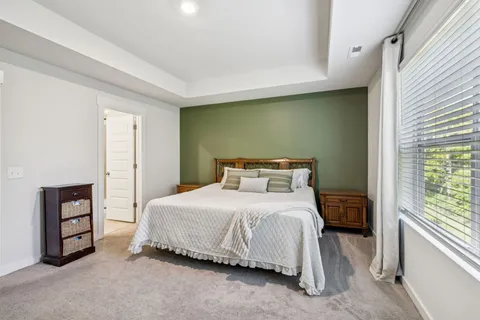 a bedroom with a bed and a television