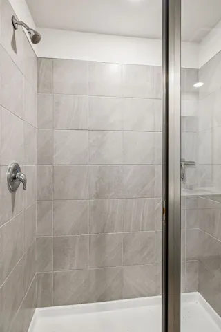 a view of walk in closet with clothes