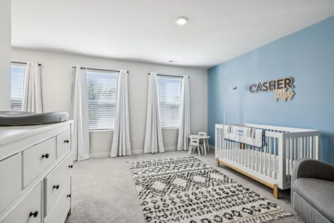 a bedroom with furniture and a window