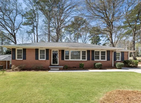 a front view of house with yard and outdoor seating