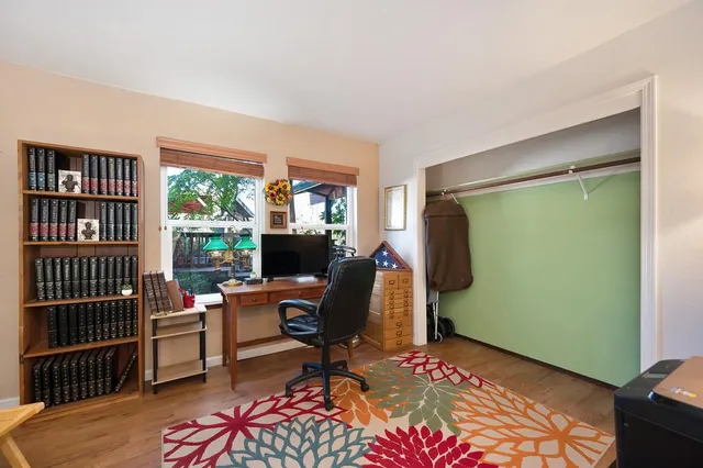 a living room with furniture a rug and a window