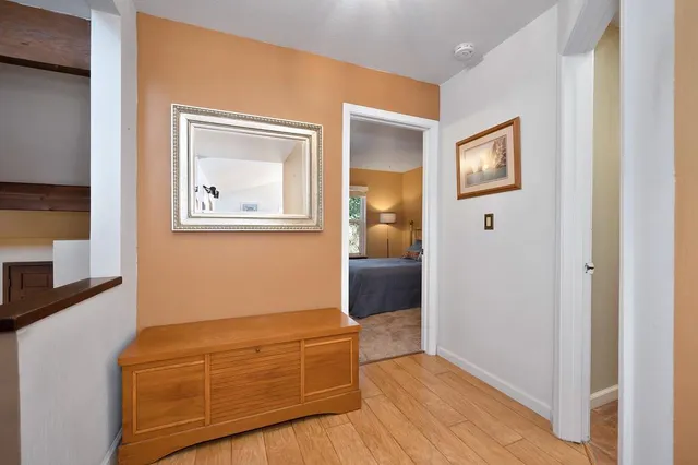 a room with wooden floor and windows