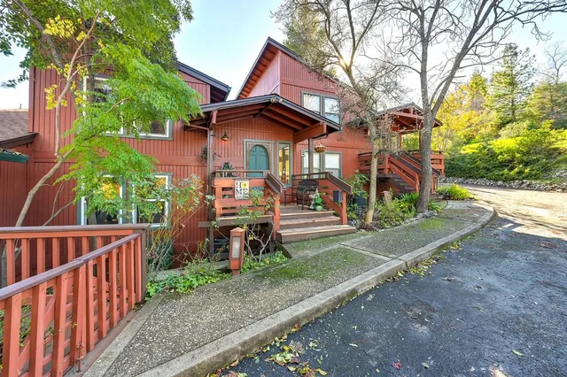 a backyard of a house with barbeque oven table and chairs