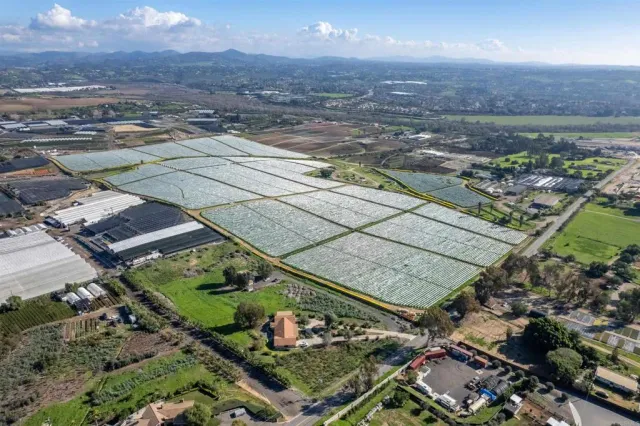 an aerial view of a residential houses with outdoor space