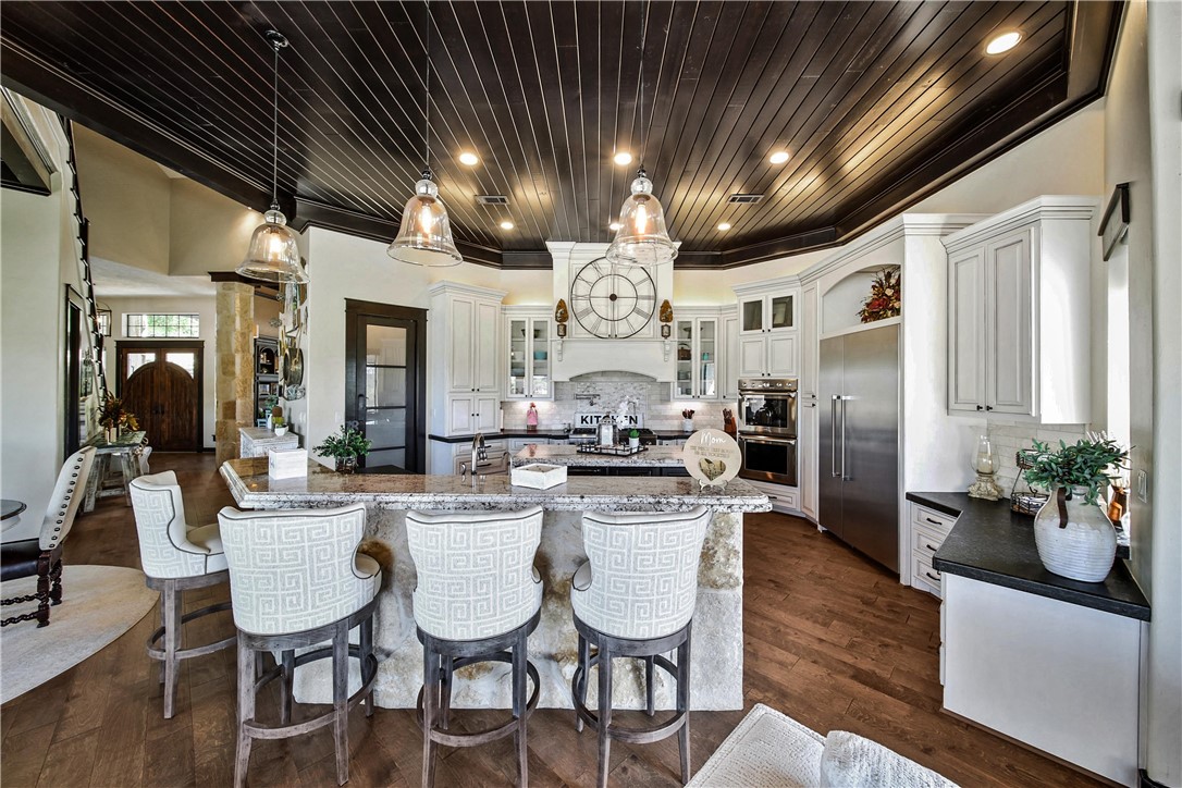 2289 Old Dobbin Road Montgomery, TX 77316 - Photo 13 of 50 a kitchen with stainless steel appliances kitchen island granite countertop a dining table chairs and granite counter tops