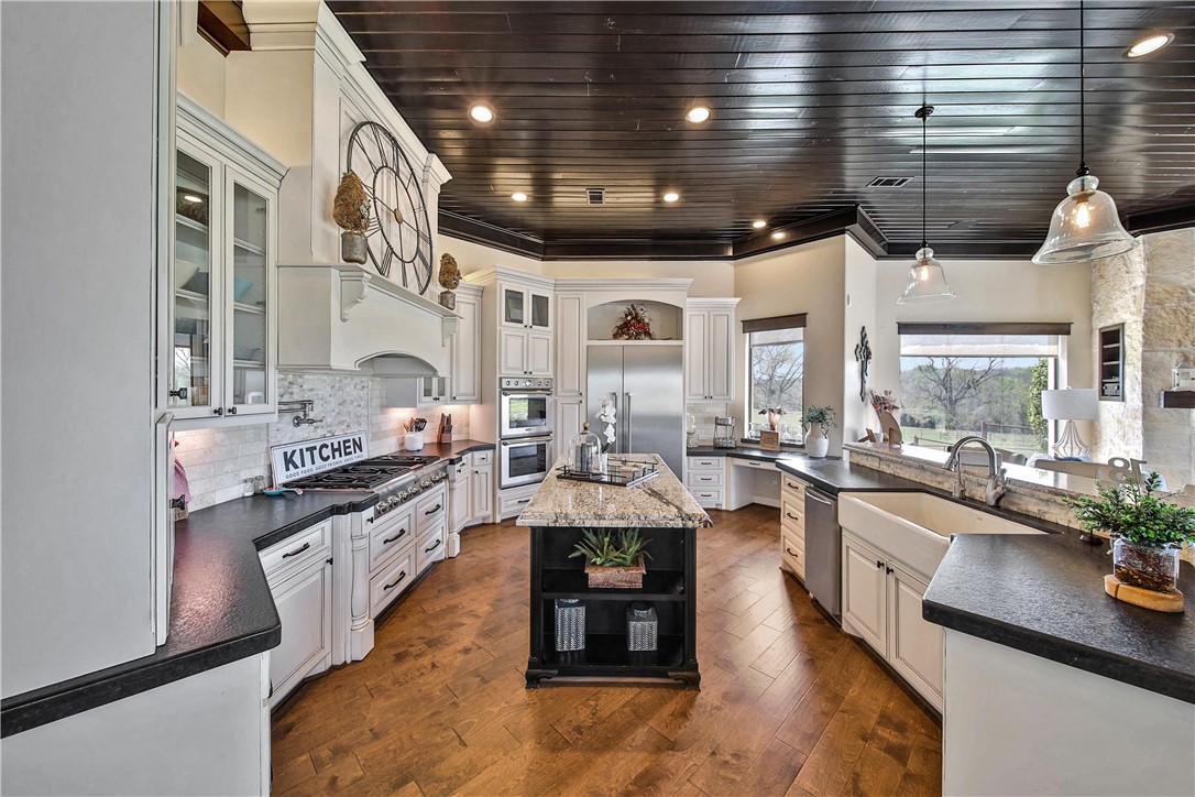 2289 Old Dobbin Road Montgomery, TX 77316 - Photo 14 of 50 a large white kitchen with lots of counter space a sink and stainless steel appliances