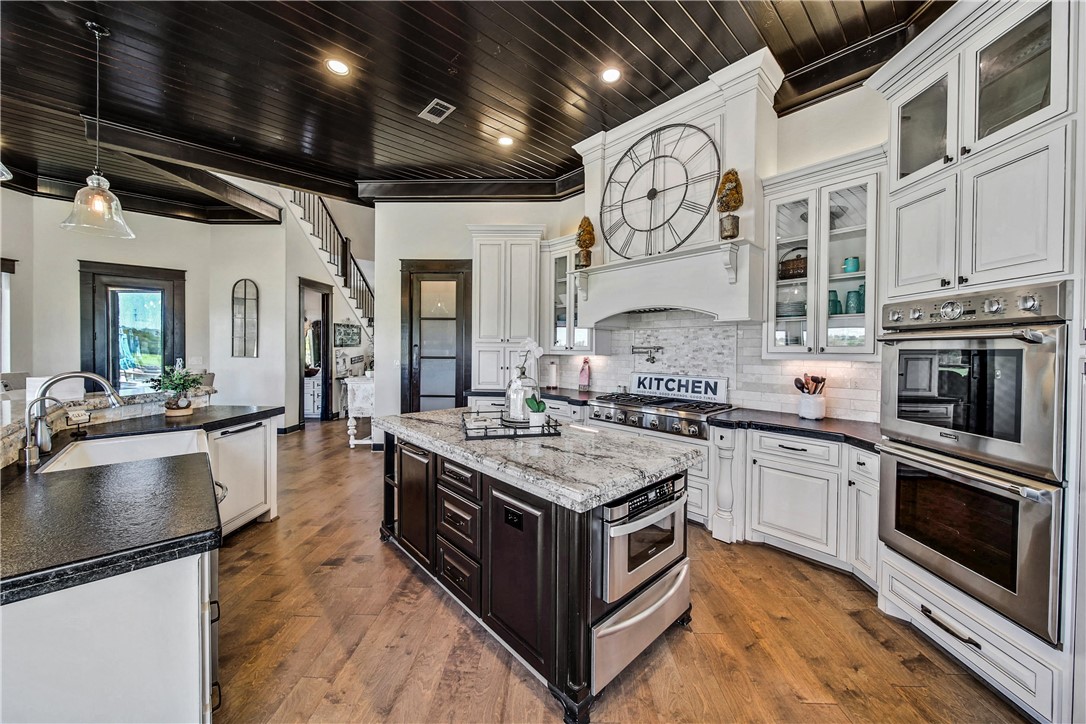 2289 Old Dobbin Road Montgomery, TX 77316 - Photo 16 of 50 a large kitchen with stainless steel appliances granite countertop a stove and a sink