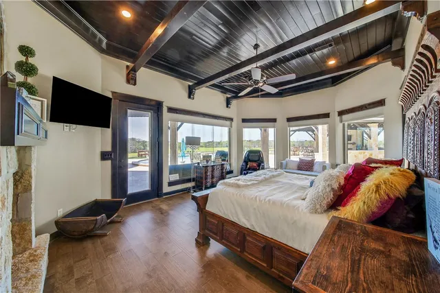 a kitchen with granite countertop a refrigerator a stove a sink dishwasher and wooden cabinets with wooden floor