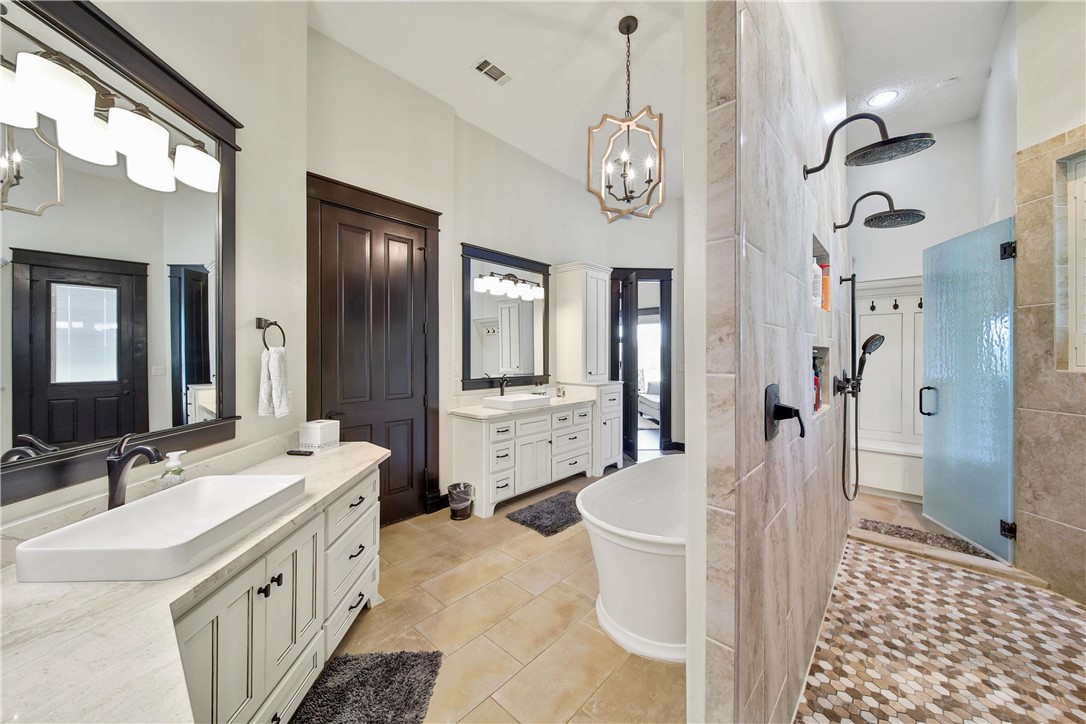 2289 Old Dobbin Road Montgomery, TX 77316 - Photo 21 of 50 a spacious bathroom with a sink a toilet a mirror a vanity and shower