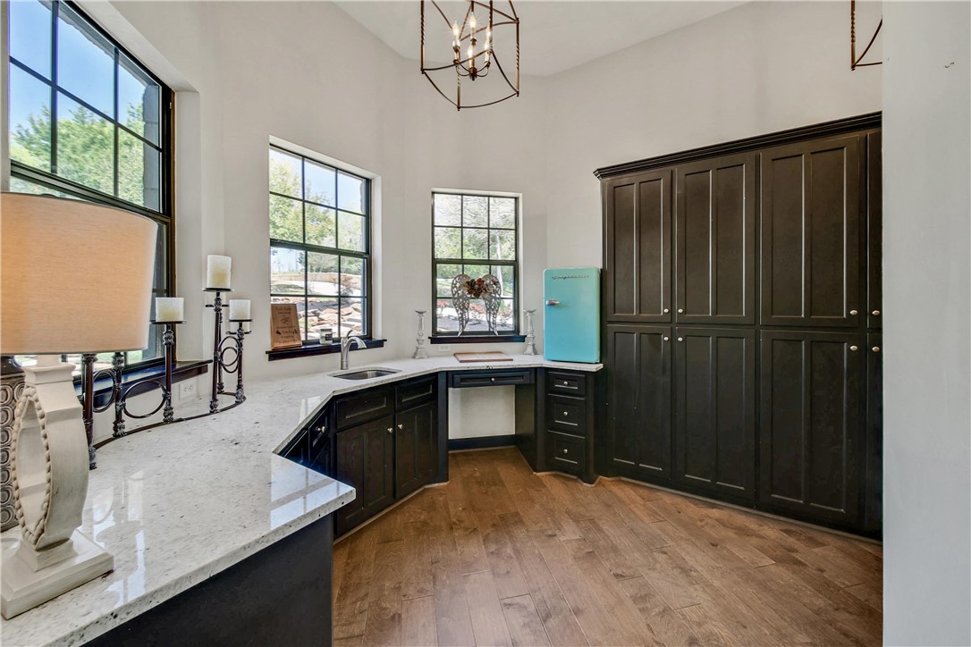 2289 Old Dobbin Road Montgomery, TX 77316 - Photo 23 of 50 a kitchen with granite countertop a refrigerator a stove a sink dishwasher and wooden cabinets with wooden floor