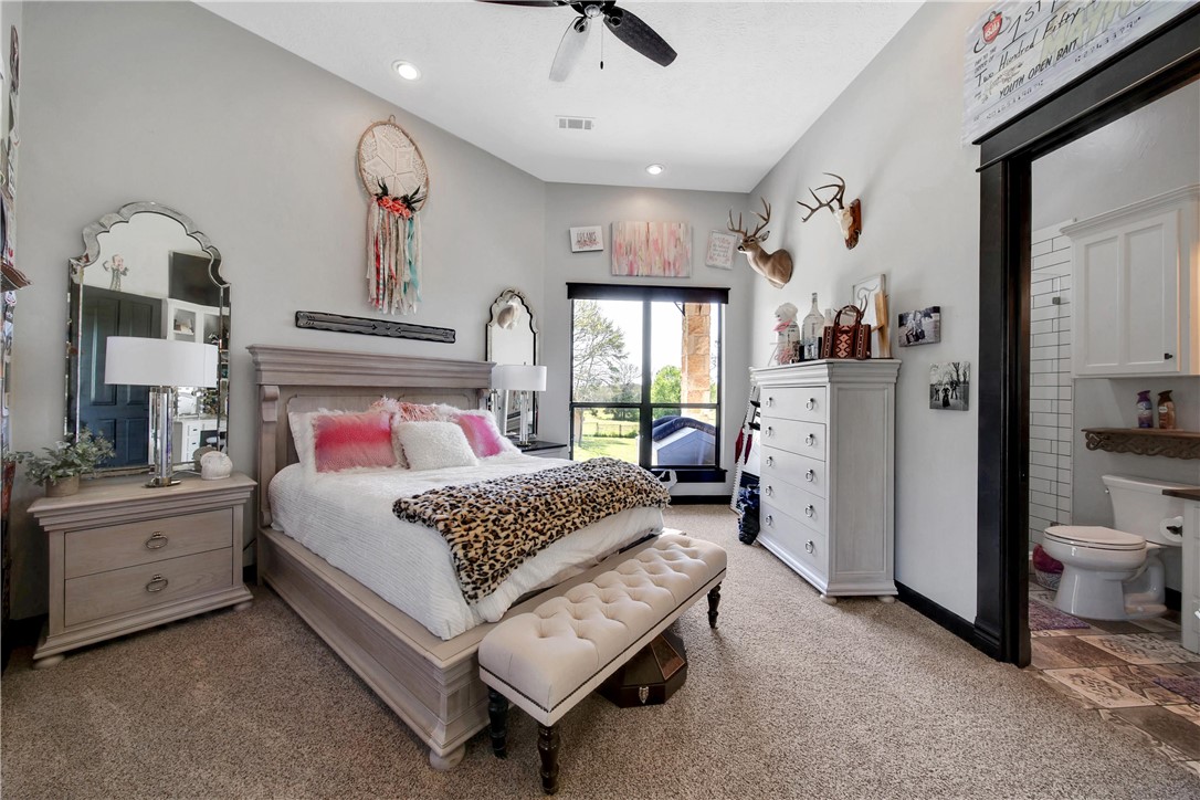 2289 Old Dobbin Road Montgomery, TX 77316 - Photo 27 of 50 a bedroom with a bed and a chandelier