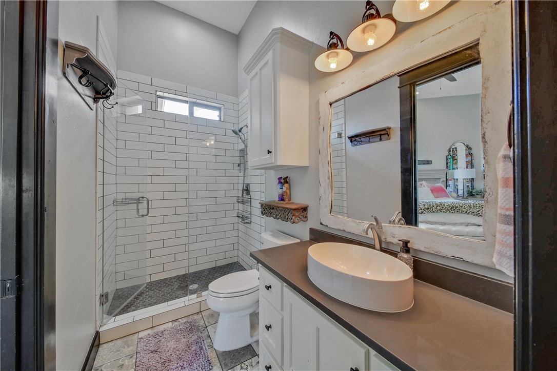 2289 Old Dobbin Road Montgomery, TX 77316 - Photo 28 of 50 a bathroom with a sink a toilet and shower