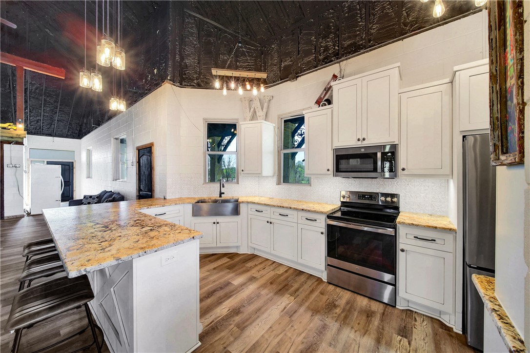 2289 Old Dobbin Road Montgomery, TX 77316 - Photo 37 of 50 a kitchen with stainless steel appliances granite countertop a stove refrigerator and a sink