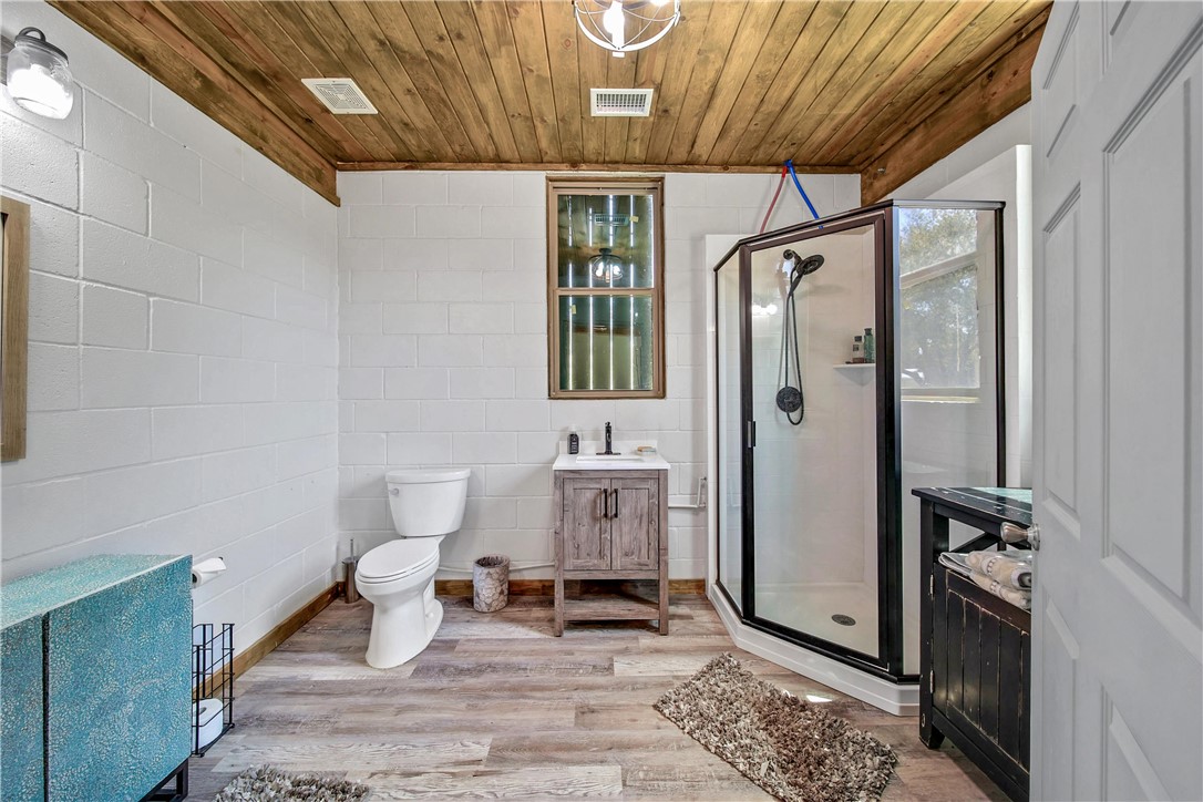 2289 Old Dobbin Road Montgomery, TX 77316 - Photo 40 of 50 a bathroom with a toilet a sink and mirror