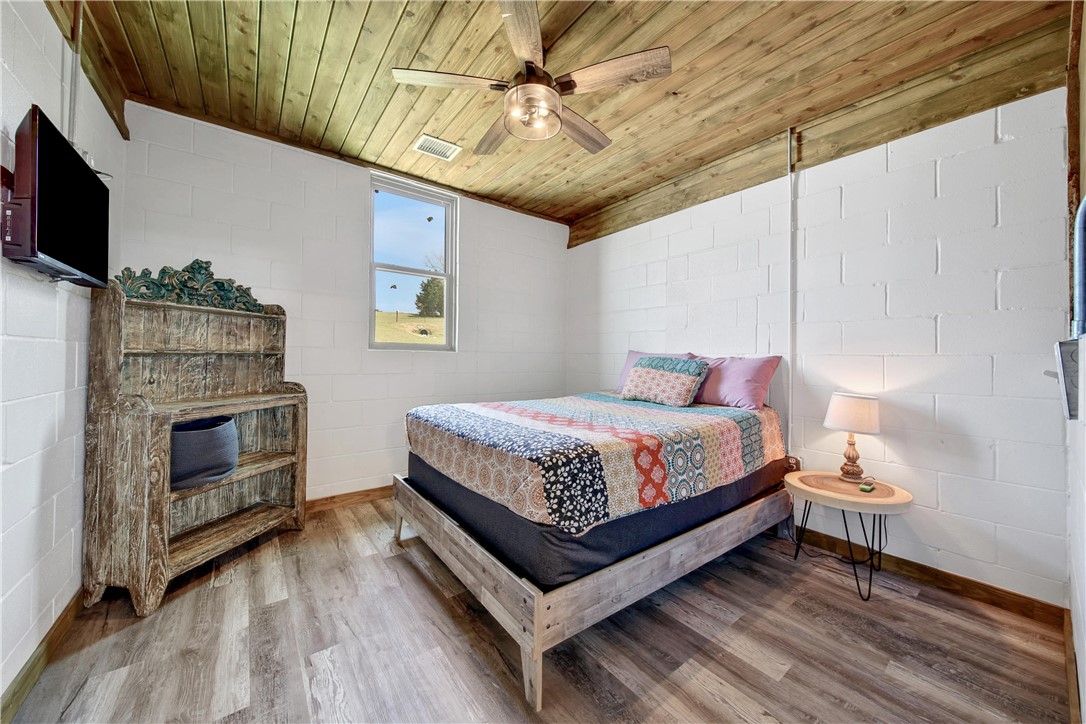 2289 Old Dobbin Road Montgomery, TX 77316 - Photo 41 of 50 a bedroom with a bed and a flat screen tv