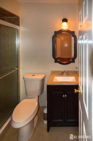 a bathroom with a sink toilet and mirror