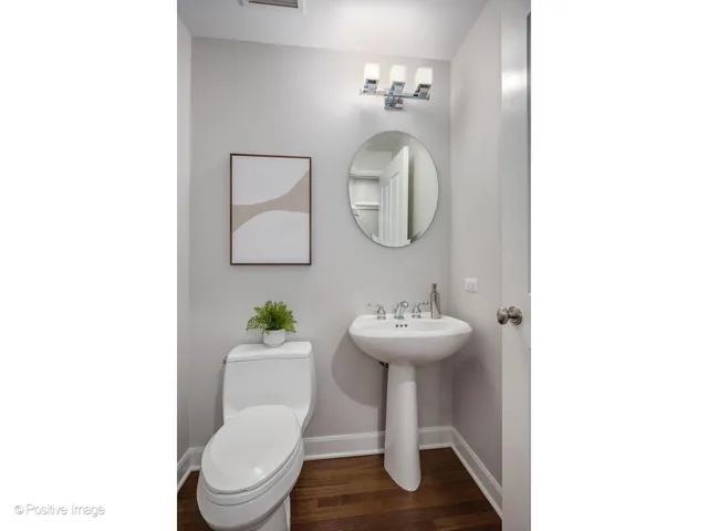 a bathroom with a sink toilet and a mirror