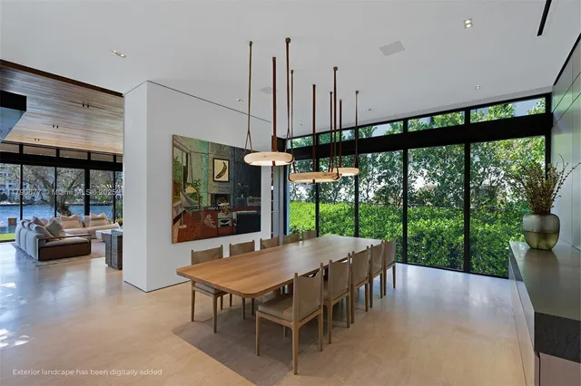 a view of a patio with couches table and chairs under an umbrella