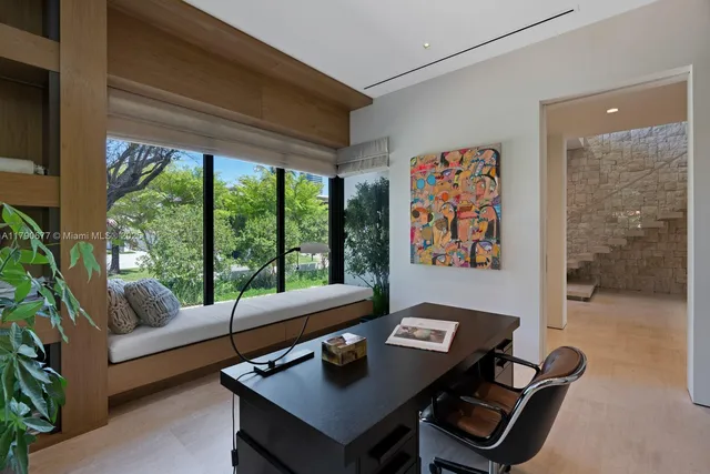a living room with furniture and a floor to ceiling window