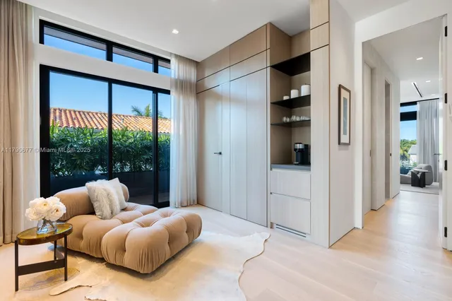 a view of a patio with couches table and chairs under an umbrella