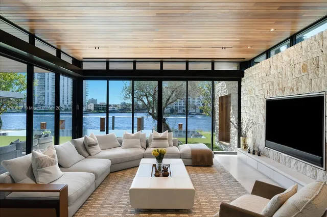 a living room with furniture a fireplace and a table