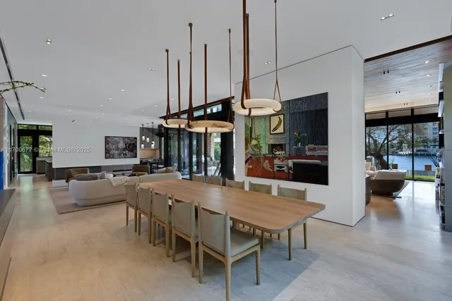 a dining room with furniture a large window and a fireplace