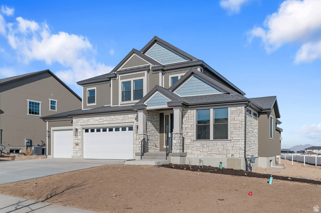 562 West Coyote Rdg Road Grantsville, UT 84029 - Photo 2 of 27 Contemporary two-story residence featuring a stone and siding exterior, multi-pane windows, and a covered front entry