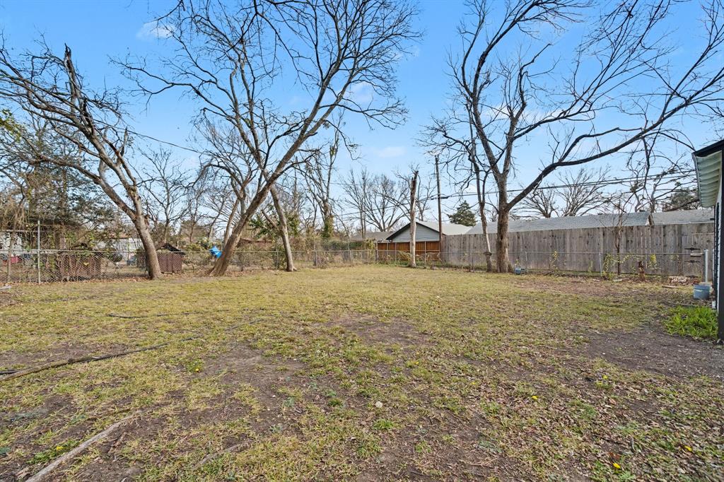11446 Lippitt Avenue Dallas, TX 75218 - Photo 23 of 26 a backyard of a house with lots of green space