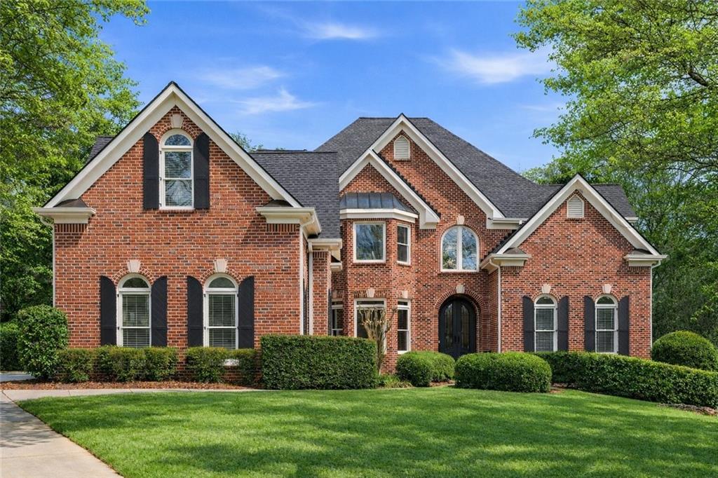 9885 Nature Mill Road Johns Creek, GA 30022 - Photo 1 of 61 a front view of a house with a yard