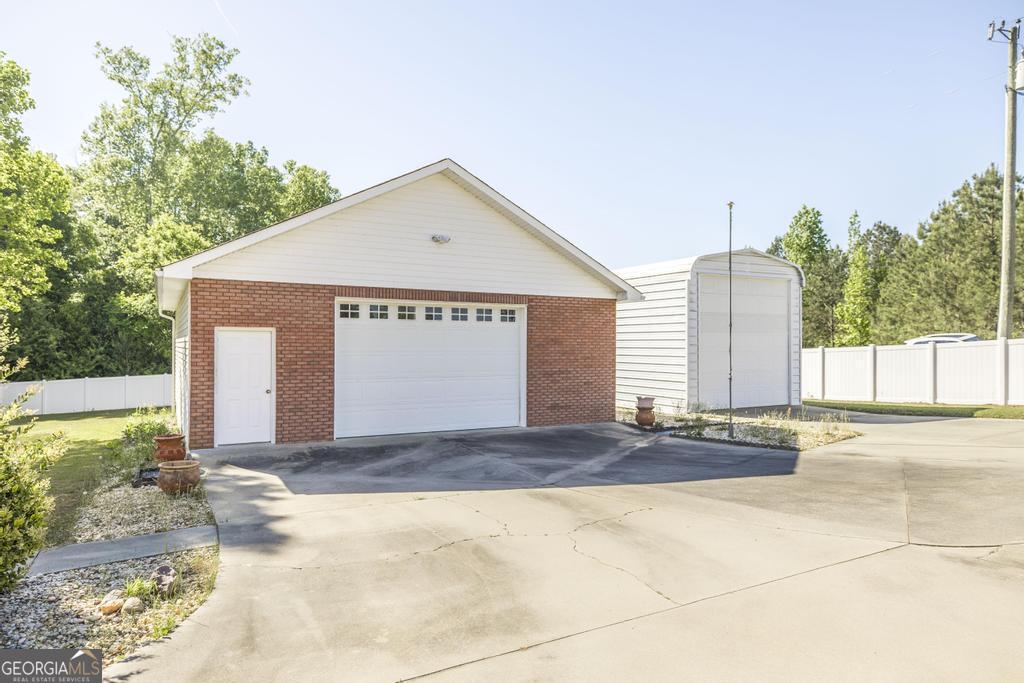 201 Strawberry Circle Dublin, GA 31021 - Photo 11 of 40 a view of a house with a yard and large tree